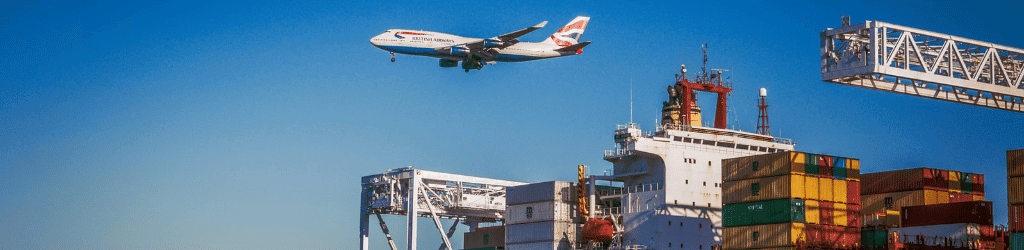 plane flying over containers